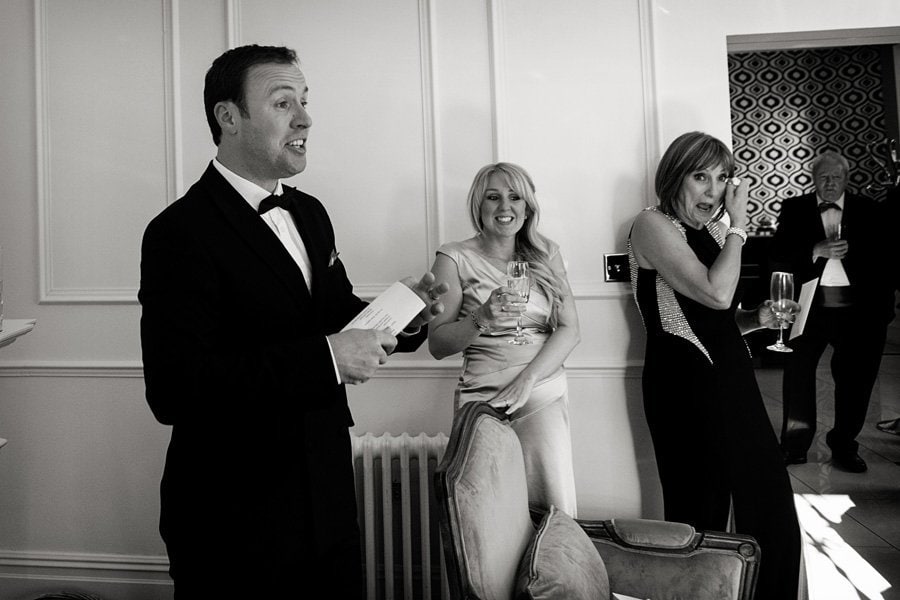 guests laughing during wedding speeches