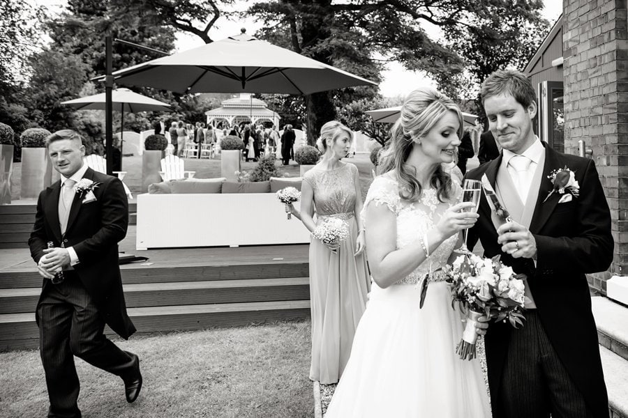 bride and groom checking glasses