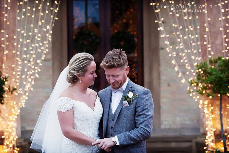 groom looking at bride's hand smiling