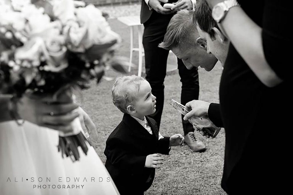 best men jokingly giving boy a drink at Old Vicarage Boutique