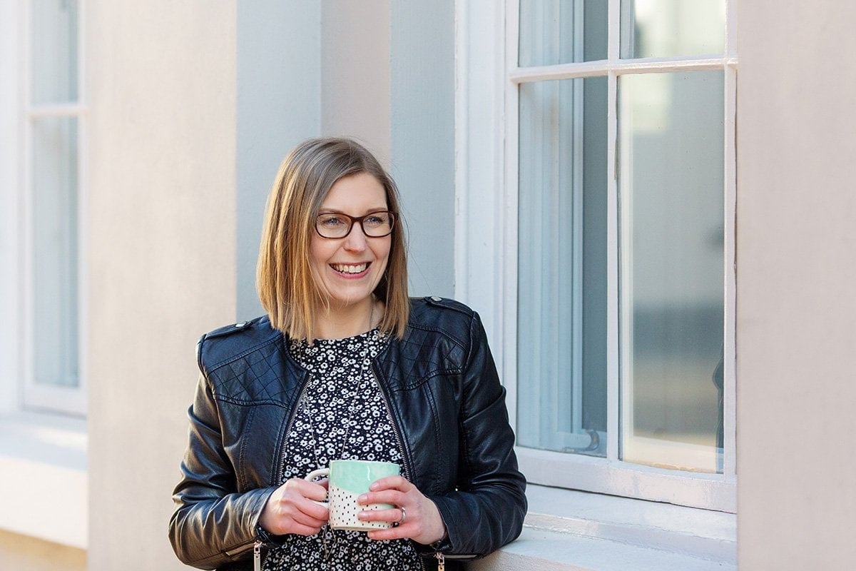creative entrepreneur on business photo shoot drinking coffee