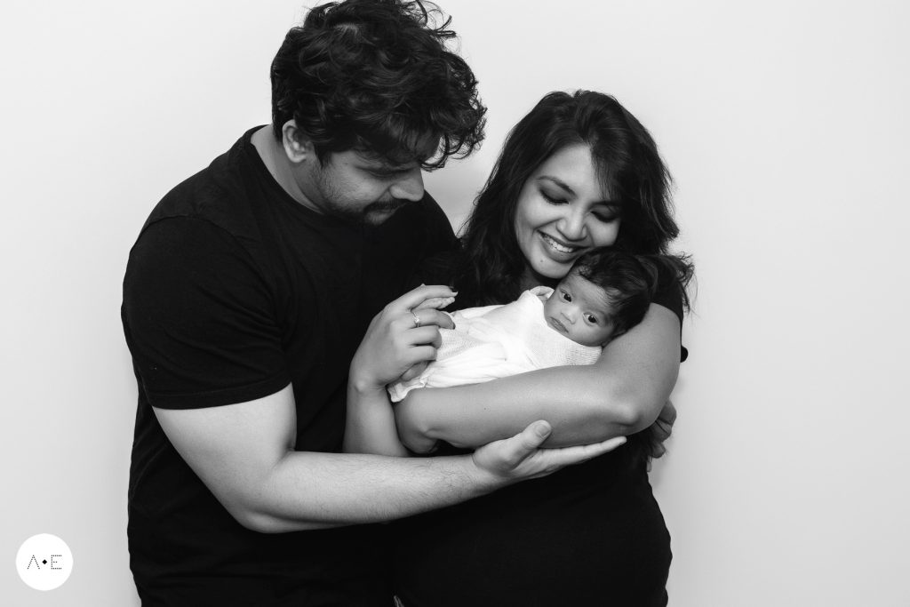 newborn pictures with parents holding baby girl