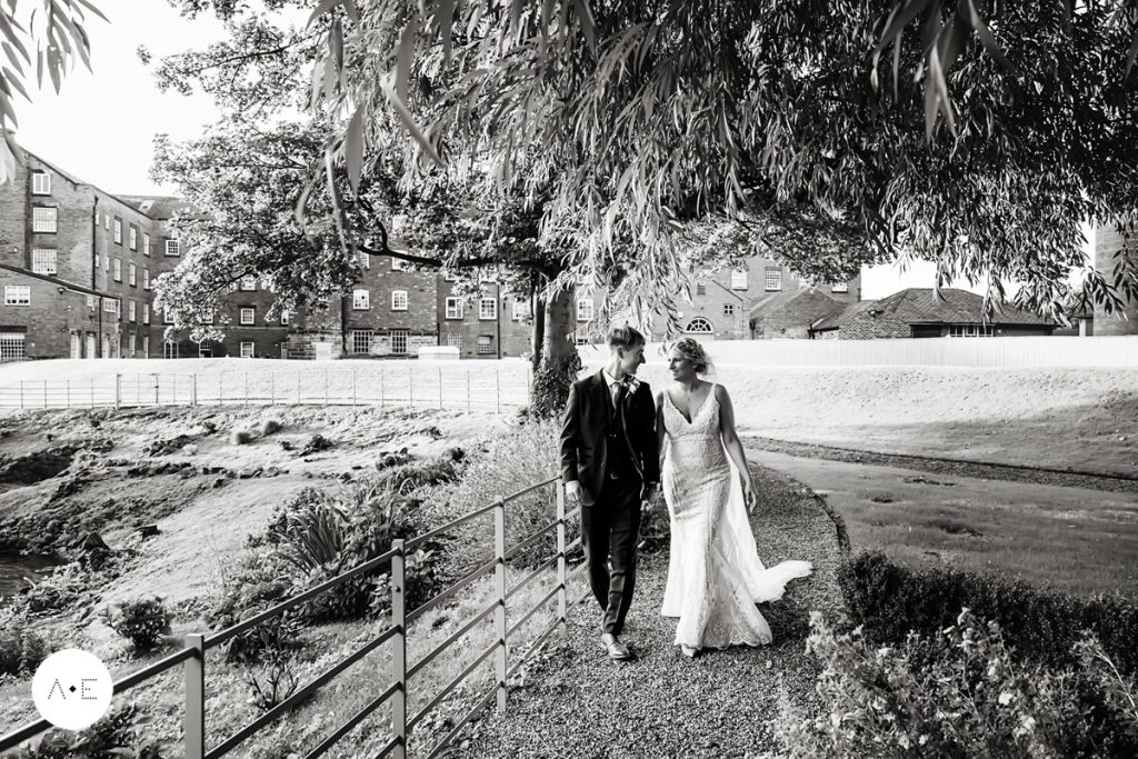 west mill wedding photography of bride and groom walking along river