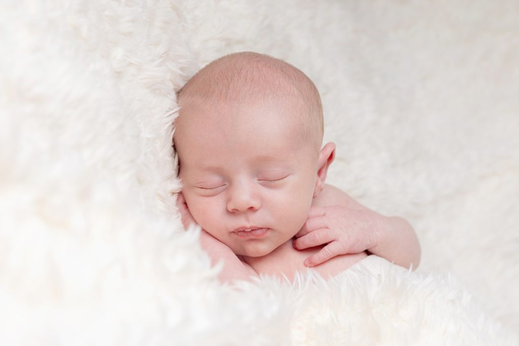 newborn boy sleeping on a blanket at home newborn photo session