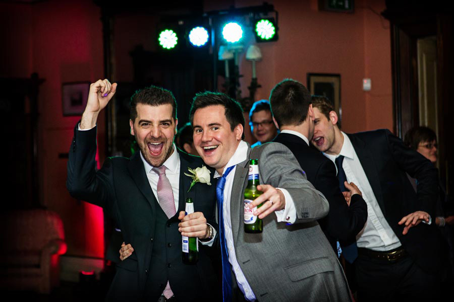 candid photo of wedding guests dancing