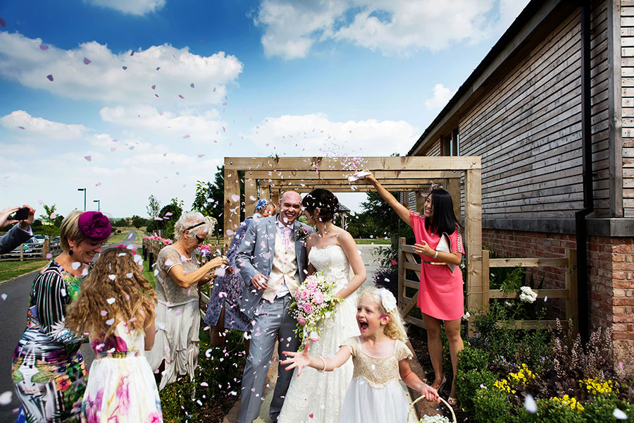 guests throwing confetti on bride and groom captured by micro wedding phtoographer Alison Edwards Photography