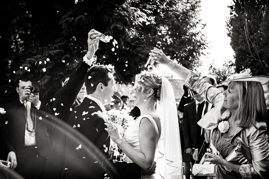 bride and groom laughing at confetti shower captured by burton on trent micro wedding photographer Alison Edwards Photography