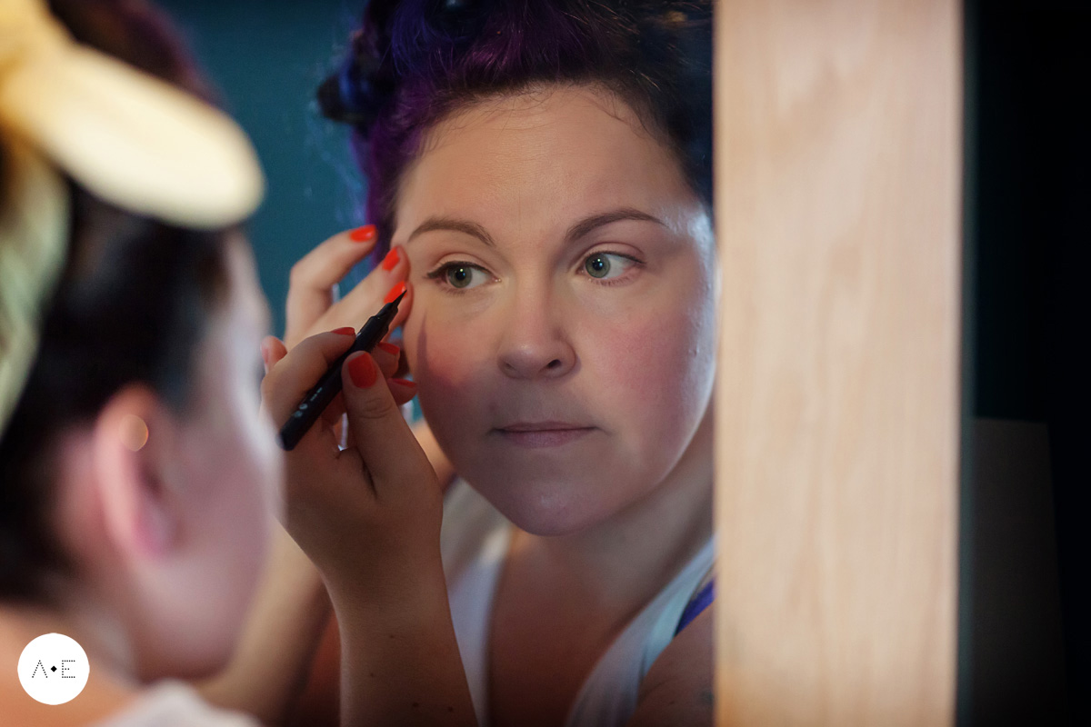 bride doing make up captured by Alison Edwards Photography Nottingham wedding photographer