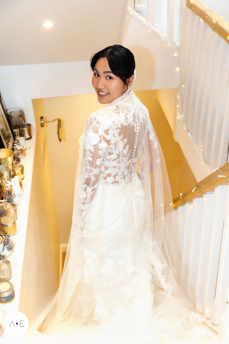 bridal portrait on staircase at country house in the Peak District photographed by Alison Edwards Photography