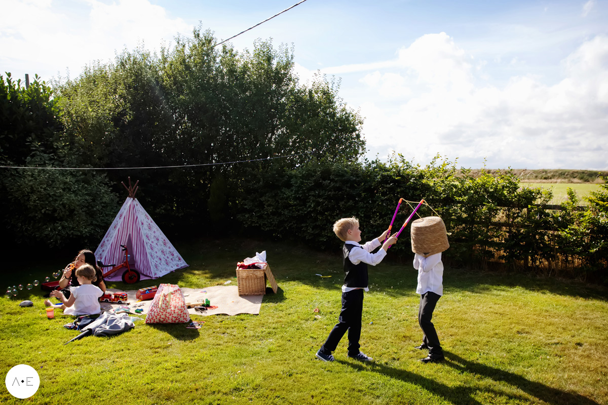 children playing in garden wedding captured by documentary wedding photographer Alison Edwards