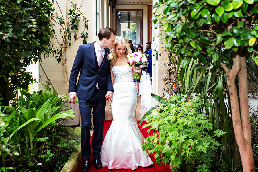 bride and groom leaving he ceremony kissing captured by Chesterfield micro wedding photographer 