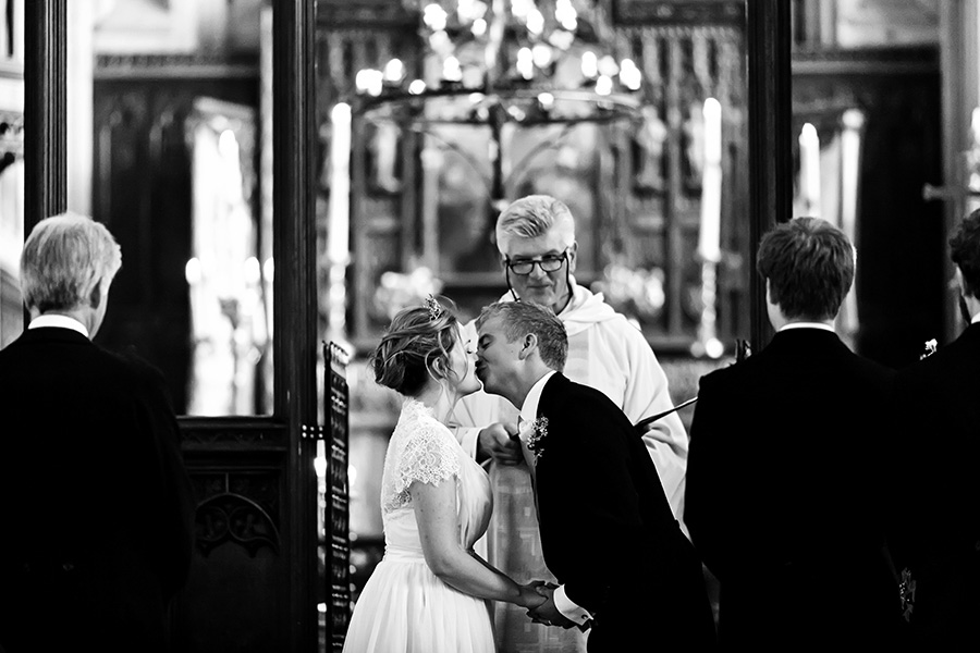 bride and groom kissing in church captured by Chesterfield wedding photographer Alison Edwards