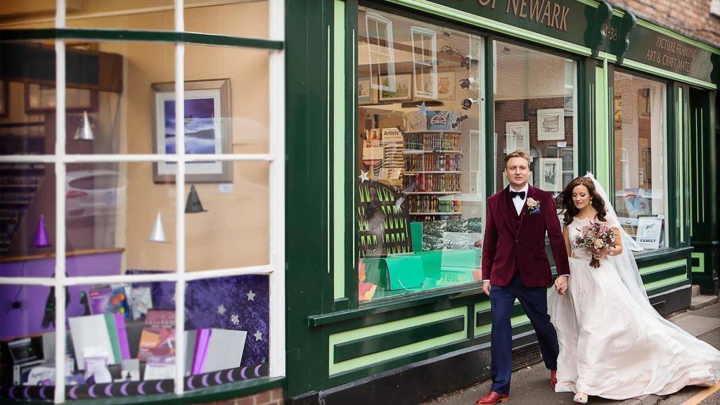 bride and groom walking down Nottingham street representing blog post for wedding photography coverage