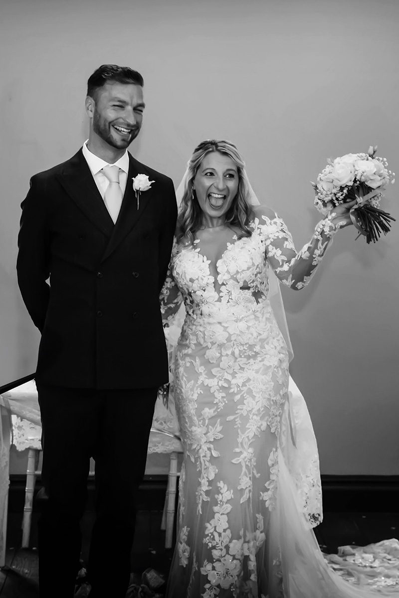 bride and groom cheering at alter captured by Nottingham wedding photogapher Alison Edwards