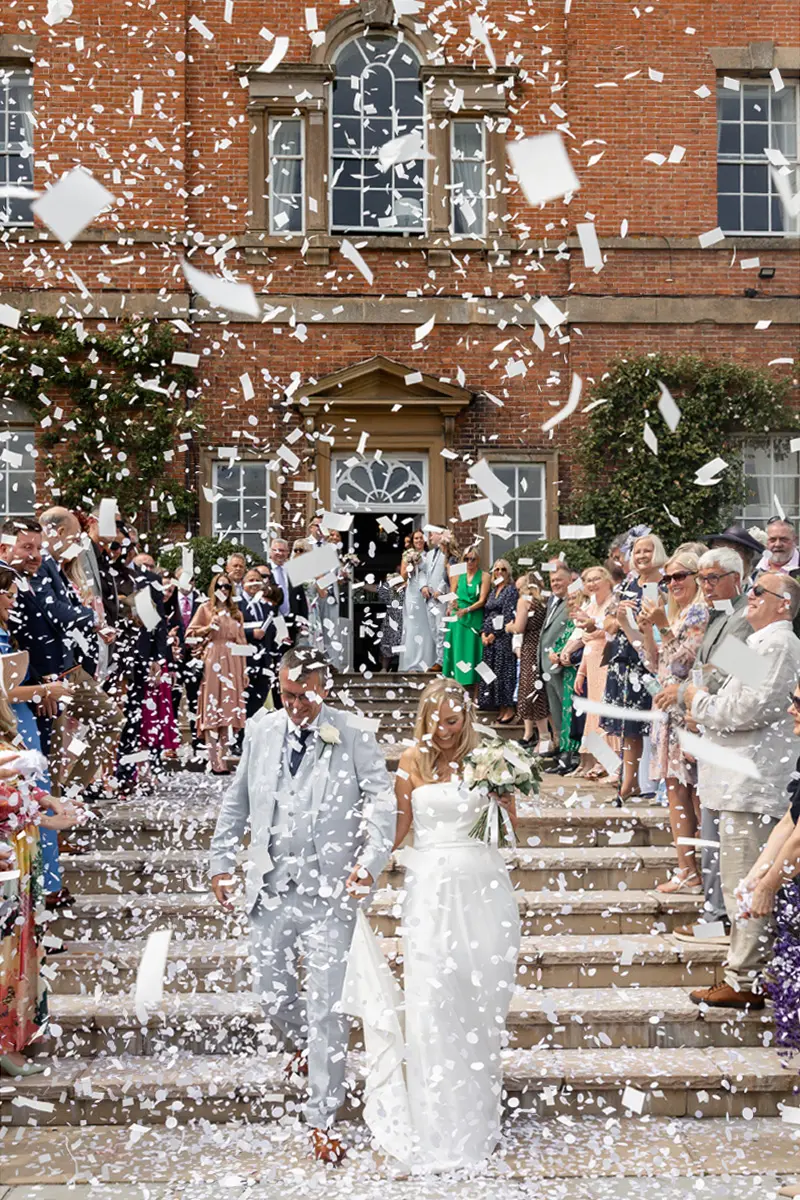 bride and groom confetti photo at Norwood Park captured by Nottingham wedding photographer Alison Edwards